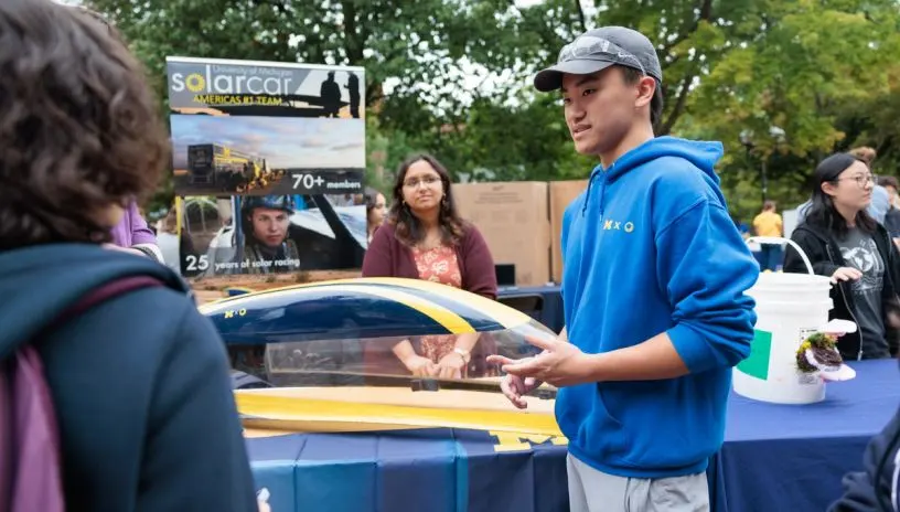 People at a race with the U-M solar car