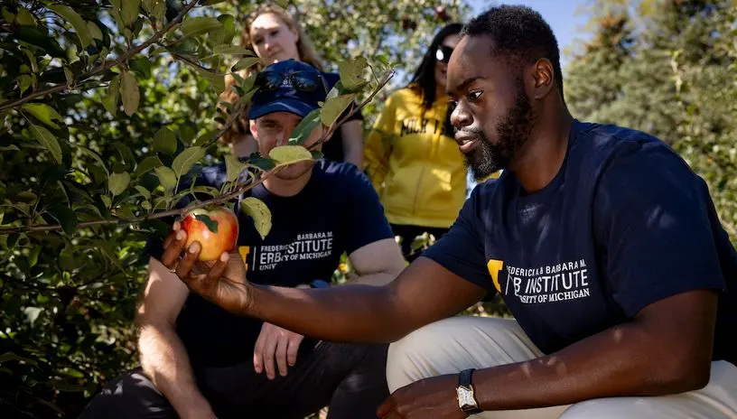 Erb Institute students in an apple orchard
