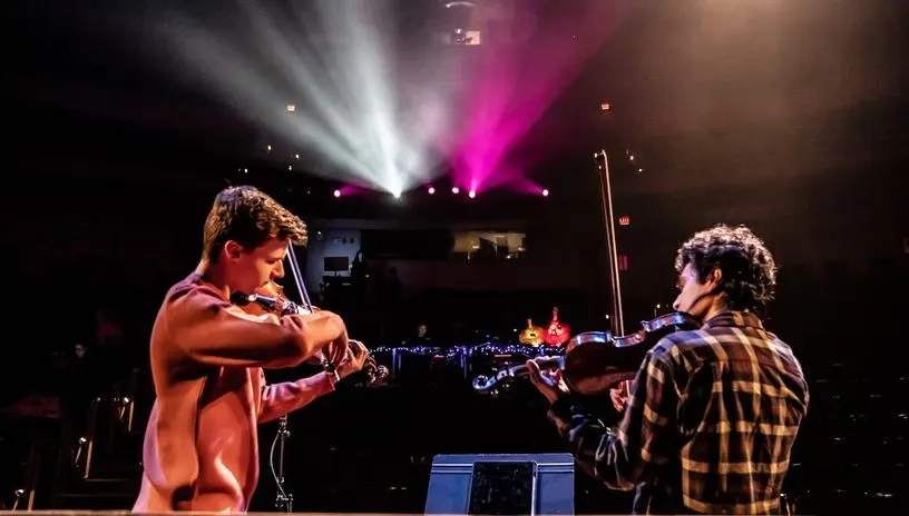 Musicians performing on stage at the Power Center