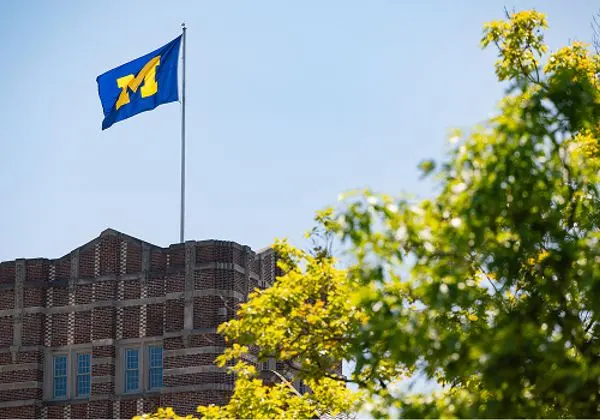 The block M flag flying at the top of the Michigan Union