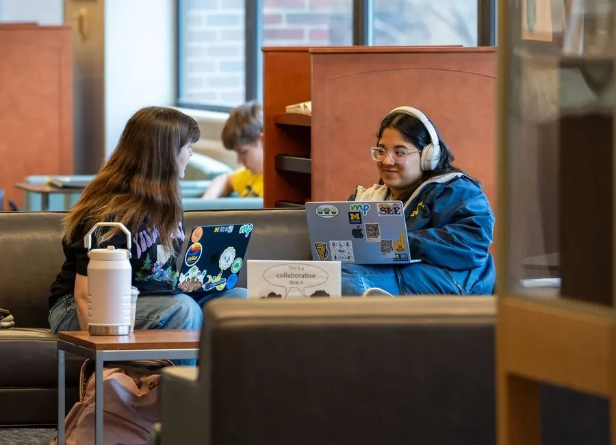 Two students chatting in a common place on campus