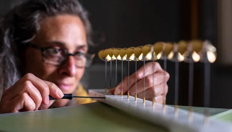 an engineer tinkers with some delicate vanes