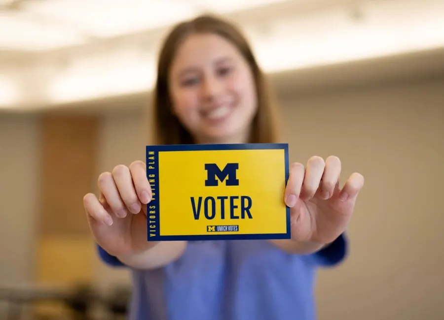 a student shows off her voting card