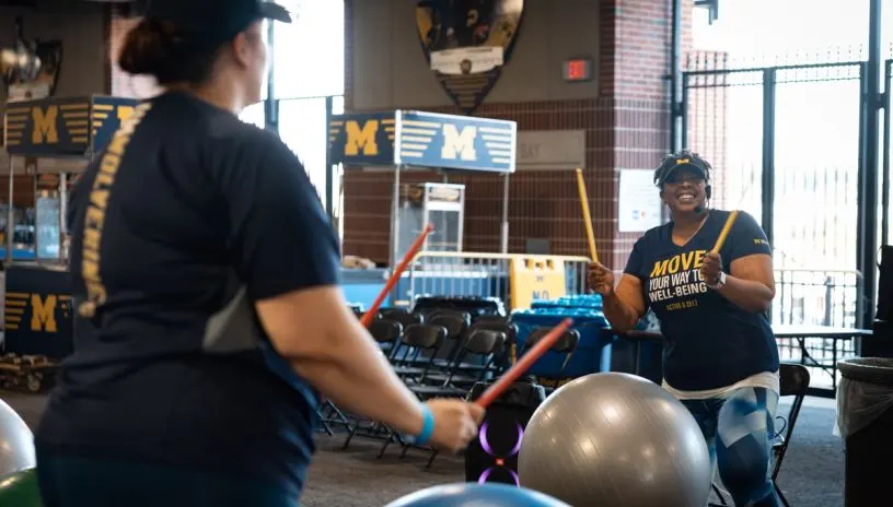 Students drumming on exercise balls